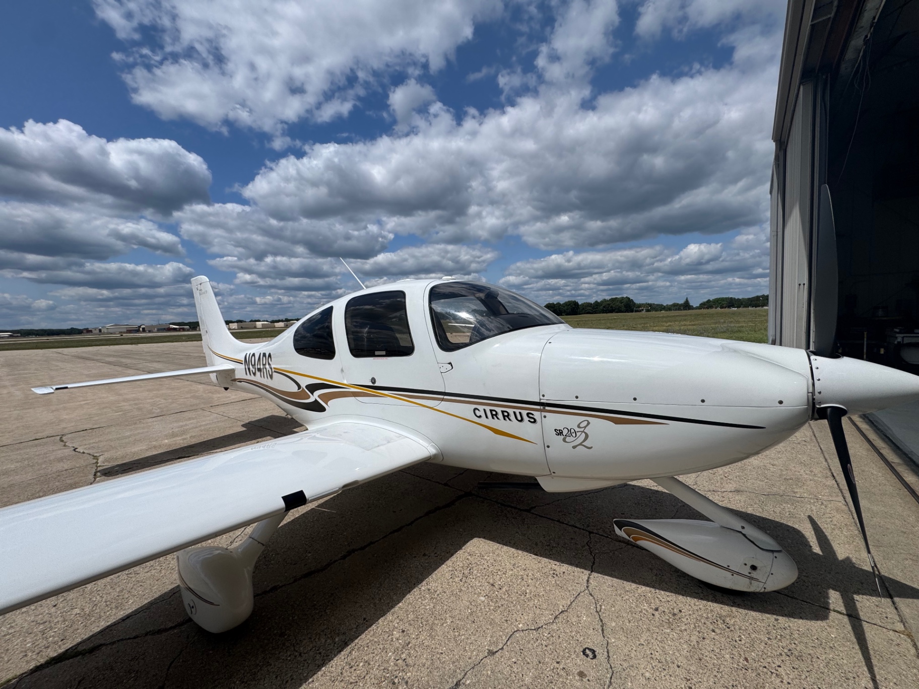 Cirrus SR20-G2 N94RS on the ramp beside the hangar